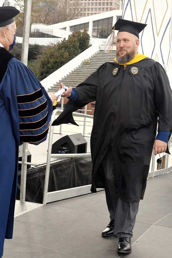 Rick Pangburn accepting his degree