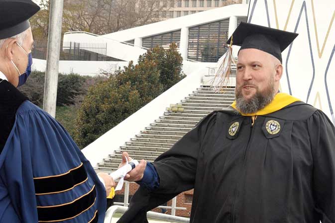 Rick Pangburn accepting his degree